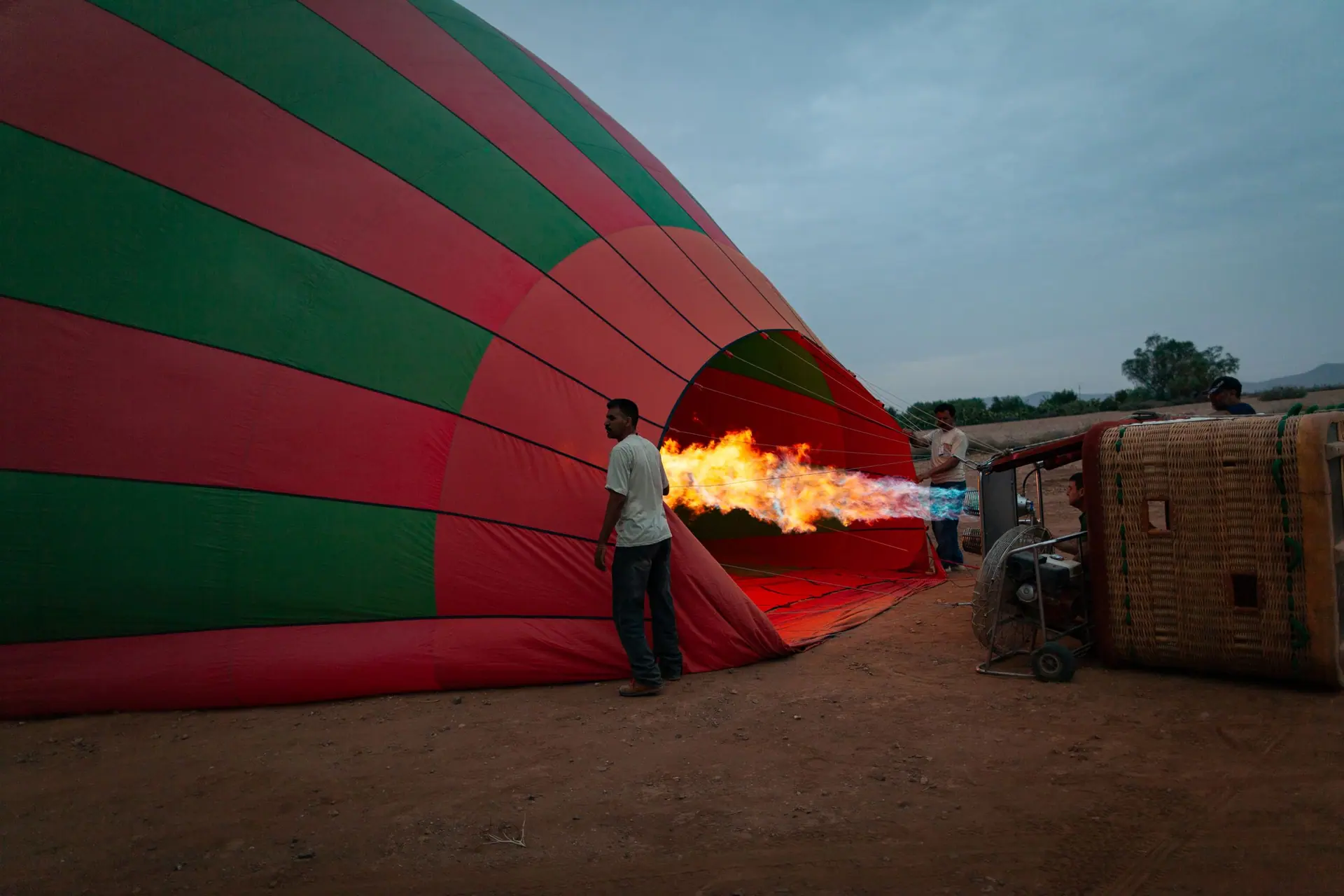 Colorful hot air balloon being inflated at sunrise in Marrakesh, Morocco.