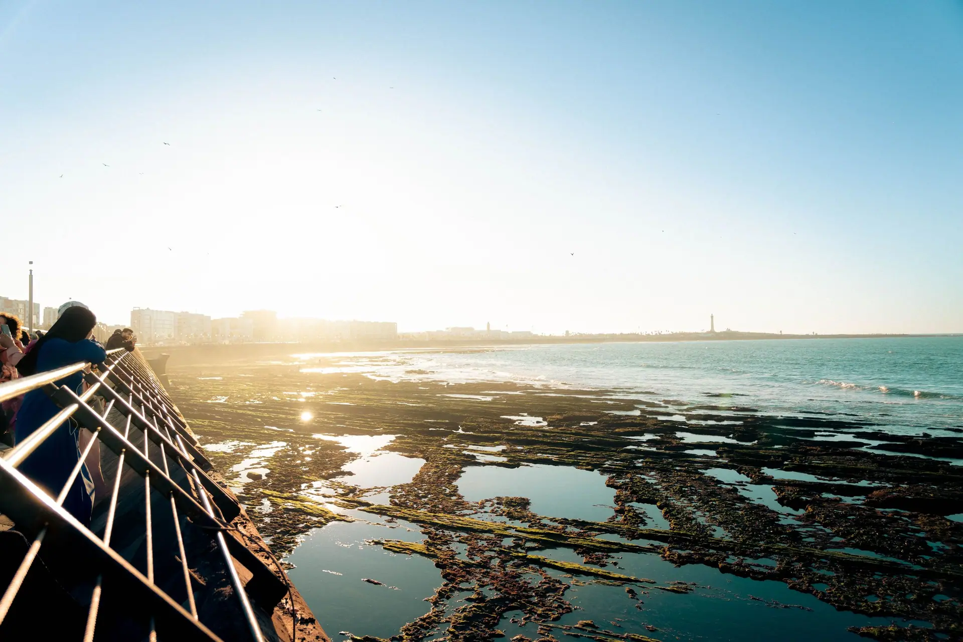 Scenic sunset view by the Casablanca coast with people enjoying the sea breeze.