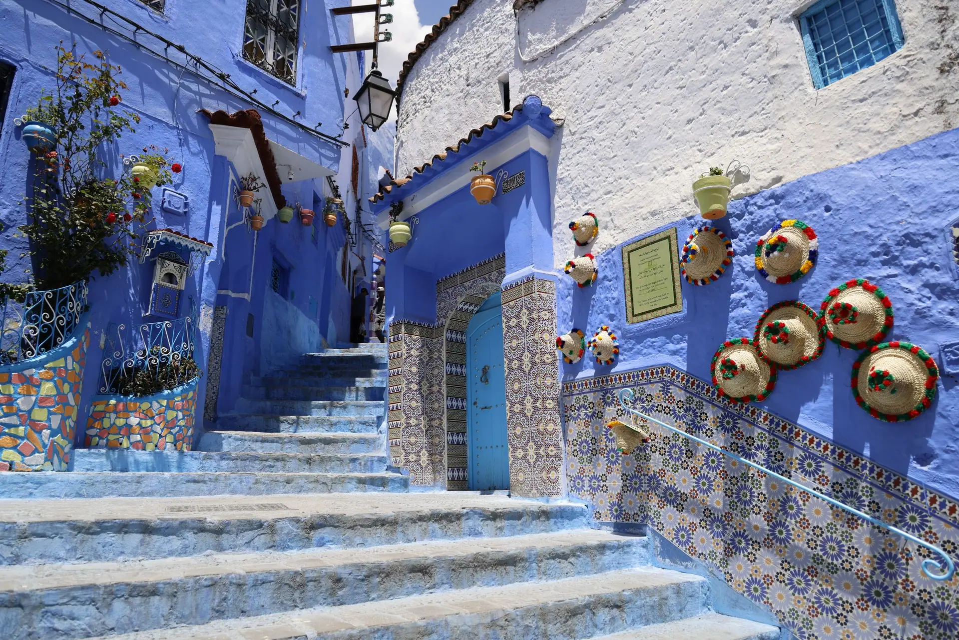 Explore the captivating blue streets of Chefchaouen, adorned with colorful pottery and traditional tiles.
